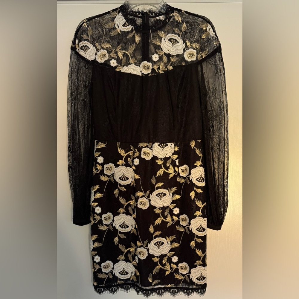 Embroidered lace dress with white and gold flowers.